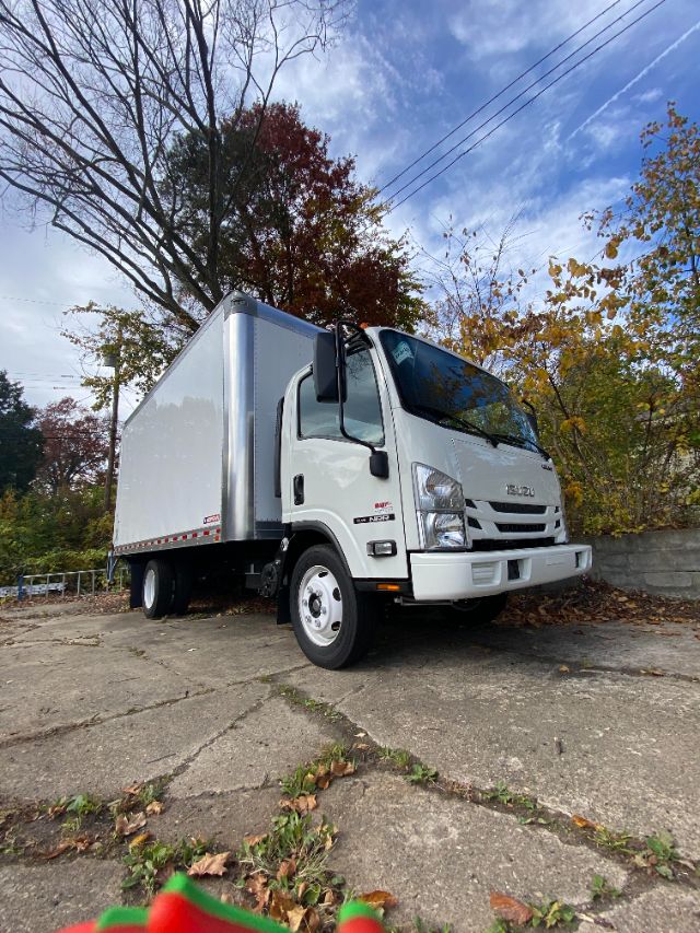 Isuzu NRR gas cab chassis truck with box body, front three-quarter view showing cab and cargo box.