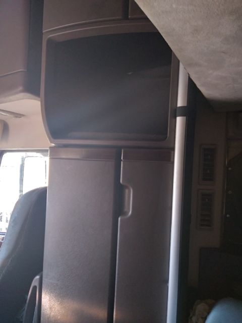 Truck cab interior showing dashboard area and storage compartments. No visible labels or text.