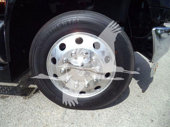 Wheel with Continental tire on a truck front. Visible text on tire sidewall includes 'CONTINENTAL' and other markings.