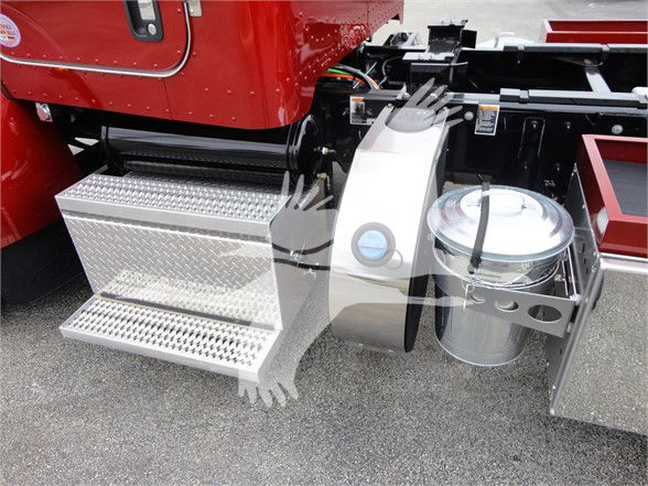 Truck side view showing diamond plate steps, fuel tank, and chassis area of a red Peterbilt 337.