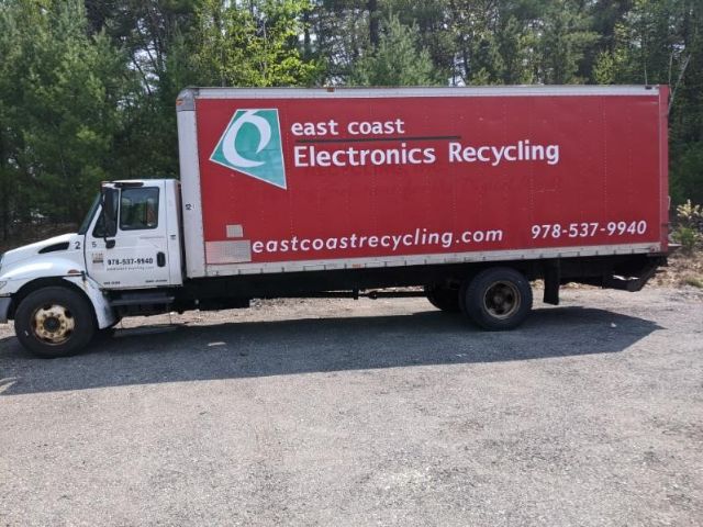 Box truck with white cab and red box display East Coast Electronics Recycling logo and contact info.