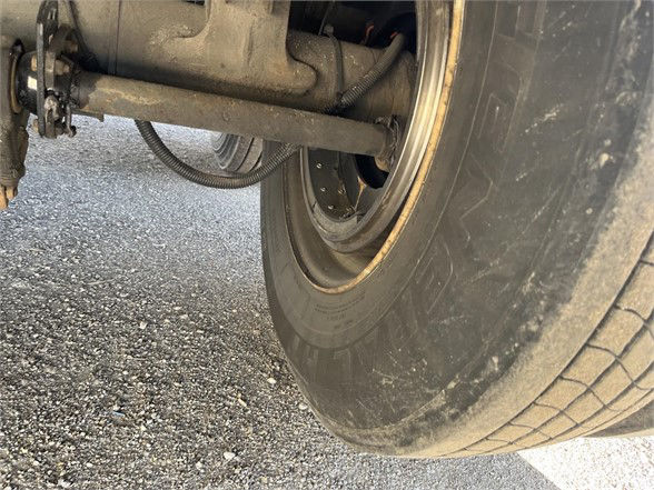 Wheel and suspension of a trailer with tire and axle visible (Vanguard trailer).