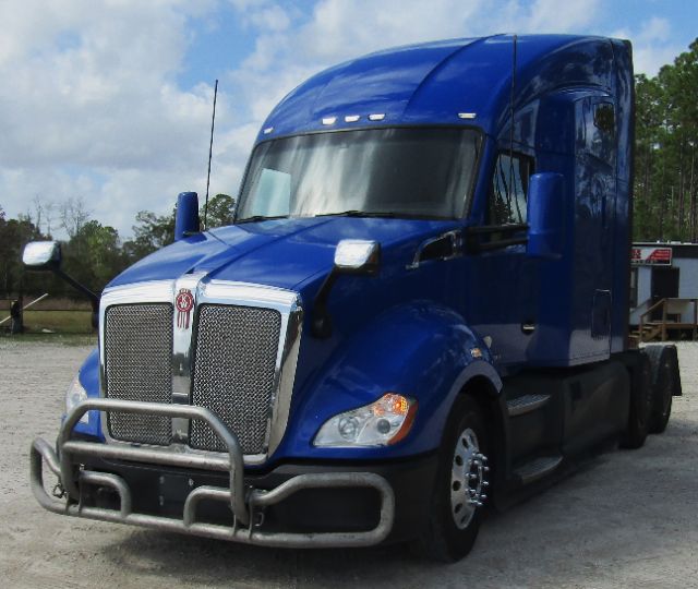 Kenworth T680 blue cab and chassis truck, front view with grille and bumper guard.