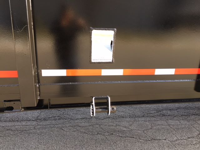 Bottom portion of a 2002 Great Dane single drop trailer showing side access ladder winch and reflective orange/white safety stripe.