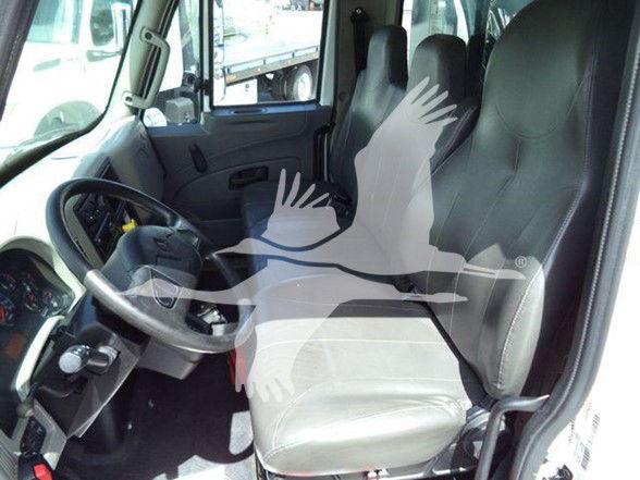 Cab interior of a 2019 International DURASTAR 4300 dump truck showing driver seat and front passenger seat with steering wheel and dashboard.