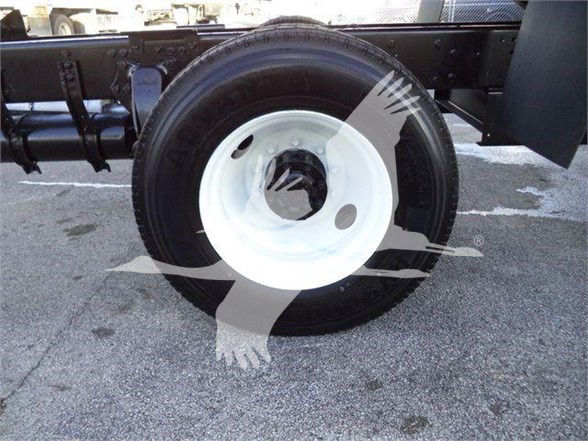 Wheel and tire assembly of a Freightliner M2 106 chassis showing white steel rim and black tire.
