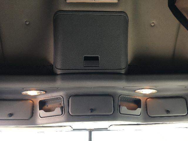 Freightliner Cascadia 125 interior overhead panel with ceiling lights and compartments.