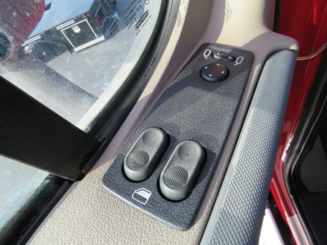 Truck interior window controls and mirror adjustment switches on the driver's door panel.
