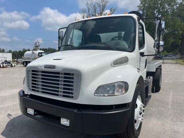 2015 Freightliner M2 sewer rodder truck front view showing white cab, black bumper, and grille with Freightliner emblem.