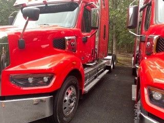 Truck cab with red Western Star 4900, side mirrors, chrome bumper, and door. Text on image includes VIN and stock number details but not fully legible in the photo.