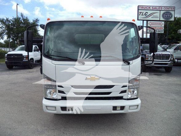Front view of a Chevrolet W4500 dump truck with a watermark graphic across the windshield. Vehicle features a Chevrolet emblem on the grille and is in a dealership lot.