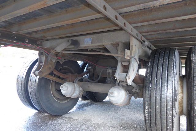 Great Dane trailer axle view showing dual rear wheels, suspension, and undercarriage components.