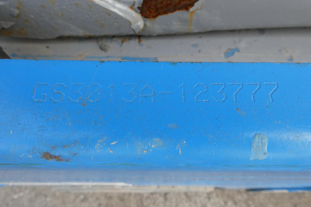 Blue plate showing the stamped VIN GS3013A-123777 on a Genie GS1930 scissor lift.