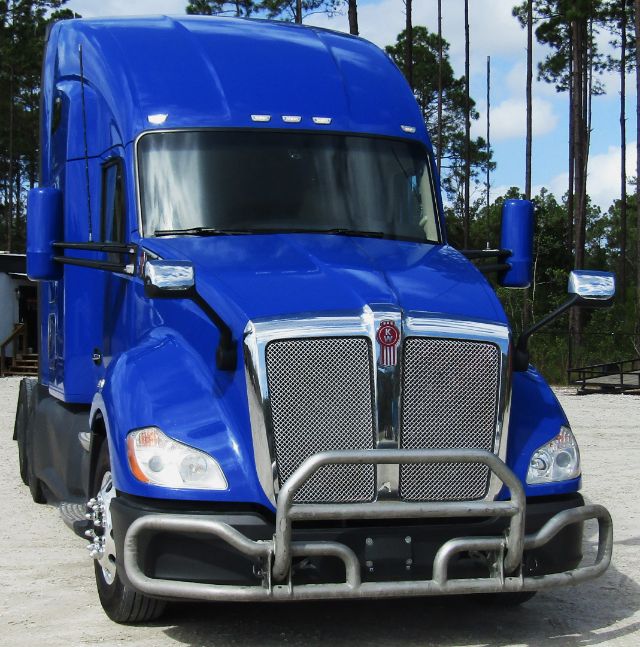Kenworth T680 blue cab and chassis front view with chrome grille and protective bull bar.