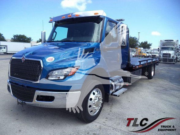 2026 International MV tow truck front-left view showing blue and gray color scheme with flatbed and TLC Truck & Equipment logo