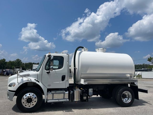 2013 Freightliner M2 sewer rodder septic truck with white tank, side view showing cab, storage steps, and hose connections.
