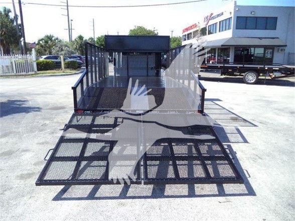 Isuzu NPR-HD truck with a flatbed trailer, rear loading ramps visible, in a dealership lot.