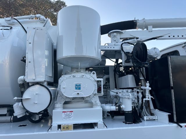 Sterling L8500 vacuum truck engine bay showing pump and hydraulic components.