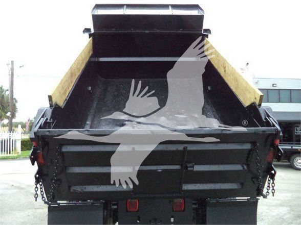 Dump truck bed of a 2017 Ford F650 SD with raised tailgate and hydraulic dump body, rear view showing black chassis, wooden sidewalls, and tail lights.