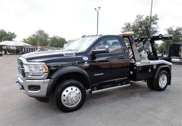 Ram 4500 HD tow truck in black, side view, featuring dual rear wheels and heavy-duty tow apparatus with EZ tow lines visible.