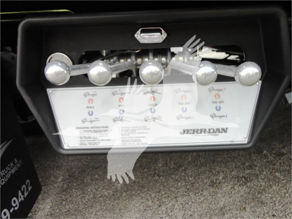 Truck engine bay accessory panel with multiple control levers and a JERR-DAN branding plate.