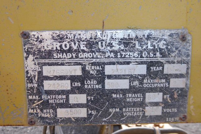 Grove T60 equipment nameplate with model M766XT, serial 34317, load rating 5000 lbs, max platform height 60 ft, max lift height 3500 lbs? (text is weathered).