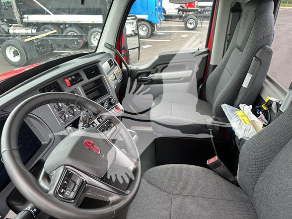 Kenworth T880 truck interior driver seat and steering wheel view.