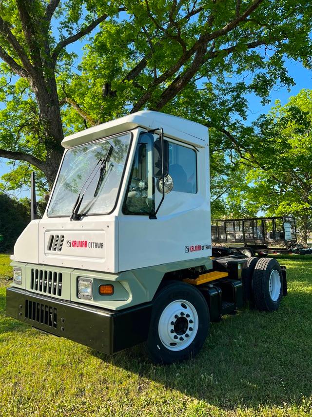 Kalmar Ottawa T2 4x2 yard truck cab and front with white body and green lower bumper, front grille, and dual rear wheels.