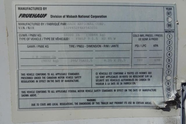 Trailer VIN plate showing manufactured by Fruehauf, division of Wabash National Corporation. Details include GVWR and axle info, tire/pneu dimensions, and caution text in English and French. Visible text includes MANUFACTURED BY FRUEHAUF, D