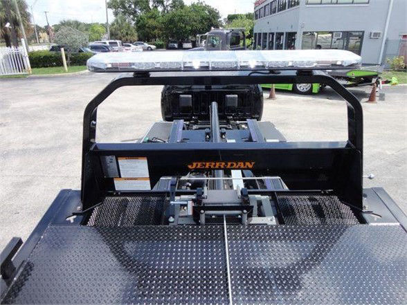 Ram 5500 tow truck bed with Jerr-Dan tow equipment and rooftop light bar visible.