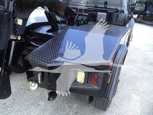 Ram 4500 Tow truck rear view showing diamond plate flatbed, taillight, wheel.