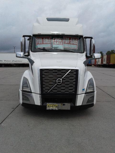 Volvo D13 truck front view showing grille, headlights, and windshield with 'FOR SALE' signs in the cab window.