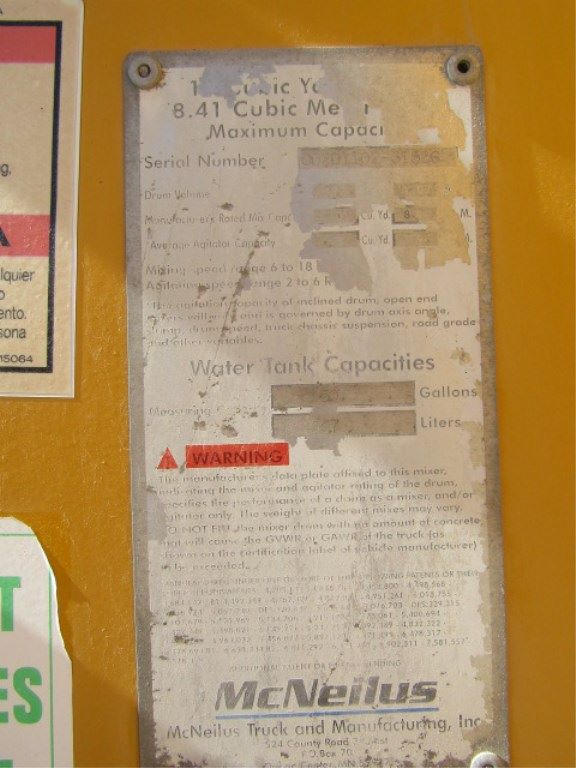 Mack CV513 truck equipment label showing water tank capacity and warnings; McNeilus branding at bottom.