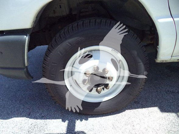 Ford E450 front right wheel showing wheel and tire with hub and fender in view.