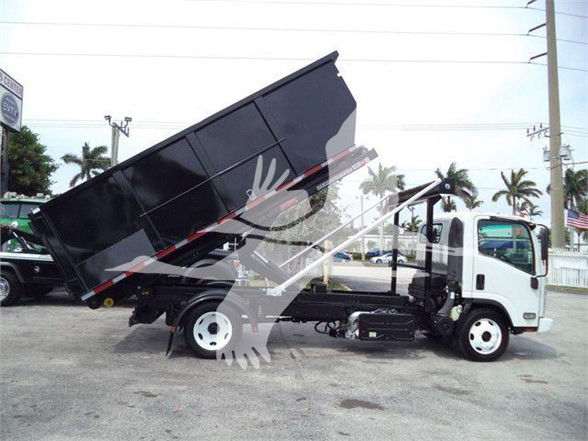 Isuzu NPR/NRR tilt-bed dump truck showing raised black bed with white cab and dual rear axles, side view.