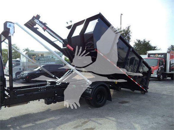 2023 Chevrolet Silverado 6500HD dump truck body on a tilt dumpster bed with hydraulic arms and dual-axle chassis.