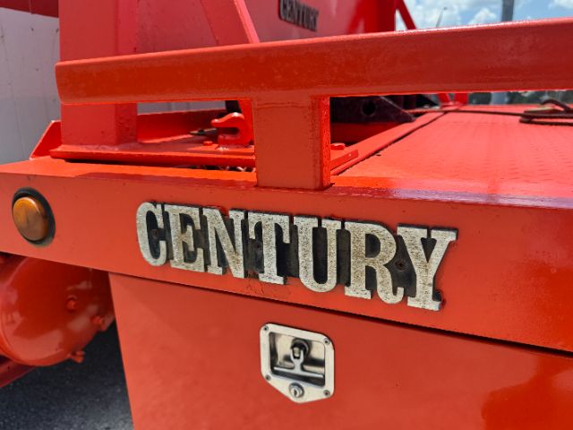 Century brand equipment with 'CENTURY' logo on orange tow truck body, storage latch visible.