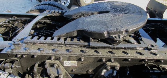 Chassis area showing rotating spare wheel and frame components on a Kenworth truck.