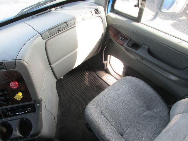 Freightliner Century truck interior showing front passenger seat and dashboard area.