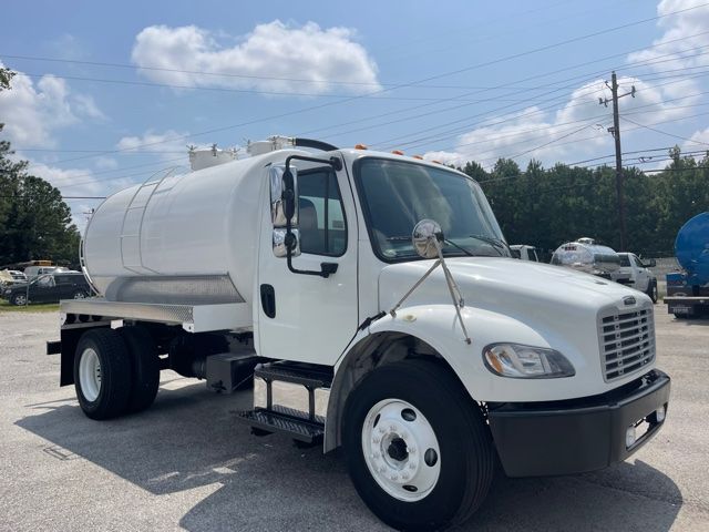 White Freightliner M2 sewer service truck with cylindrical tank and front bumper, side steps, and dual rear wheels.