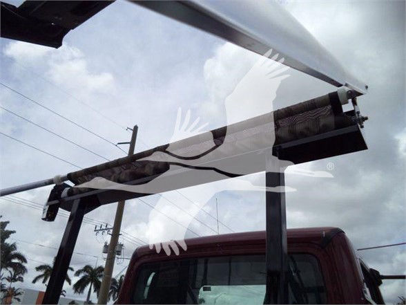 Truck cab with large rear window and equipment visible; no legible labels or text readable.