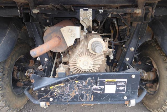 Kubota RTV-X1140 rear drivetrain showing engine, exhaust, and suspension components.