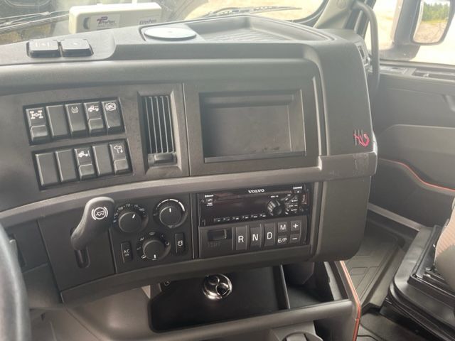 Volvo VNL64T740 truck dashboard showing climate controls, multiple switch panels, and empty screen area.