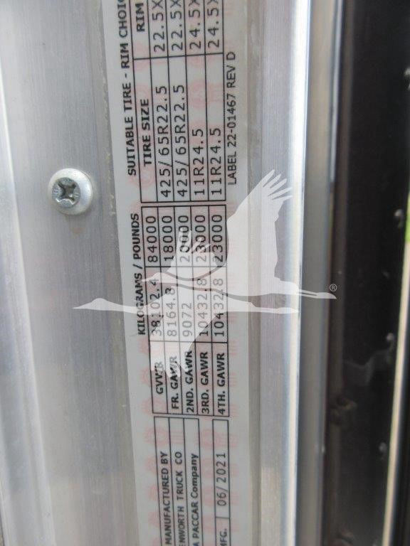 Plate on door frame with tire size, GAWR, and weights for a Kenworth W900B truck. Visible text includes 'GAVR', '2ND GAVR', '3RD GAVR', '4TH GAVR', 'GAWR', 'GVWR' and weight figures.