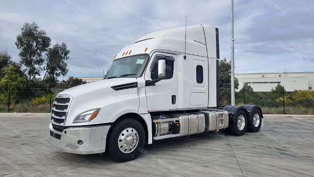 White 2022 Freightliner New Cascadia cabover sleeper semi-truck with sleeper cab, dual rear axles, chrome bumper, and fuel tanks visible.