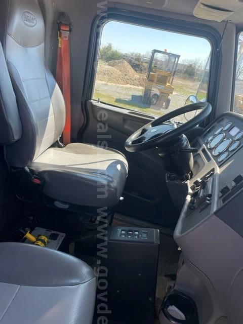 Truck cab interior of a 2012 Peterbilt 365 showing steering wheel, dashboard, and driver's seat.