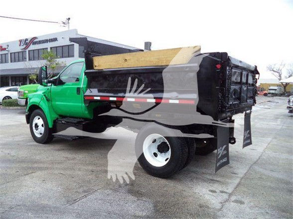 Image of a green Ford F-650 dump truck with a black dump bed, white wheels, and a wooden side panel. Brand logos or text not clearly visible.