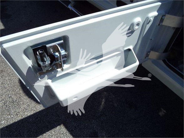 Ram 5500 tailgate step/handle area with plastic step and latch visible.
