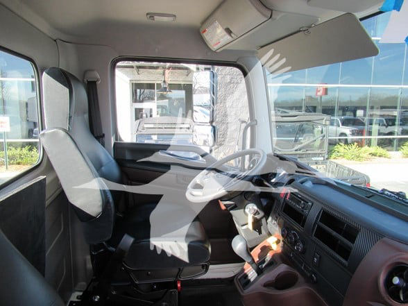 Cab and chassis truck interior showing driver and passenger seats, steering wheel, dashboard, and gear shifter.