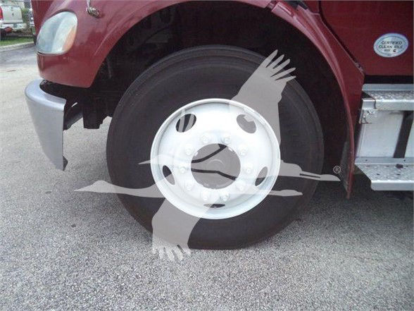 Freightliner Business Class M2 106 front wheel well and steel wheel displaying tire and fender, side step visible